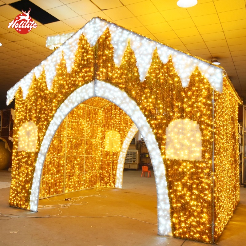 Large-scale gingerbread house-shaped holiday lighting display with a galvanized frame, waterproof LED lights, and fire-resistant tinsel