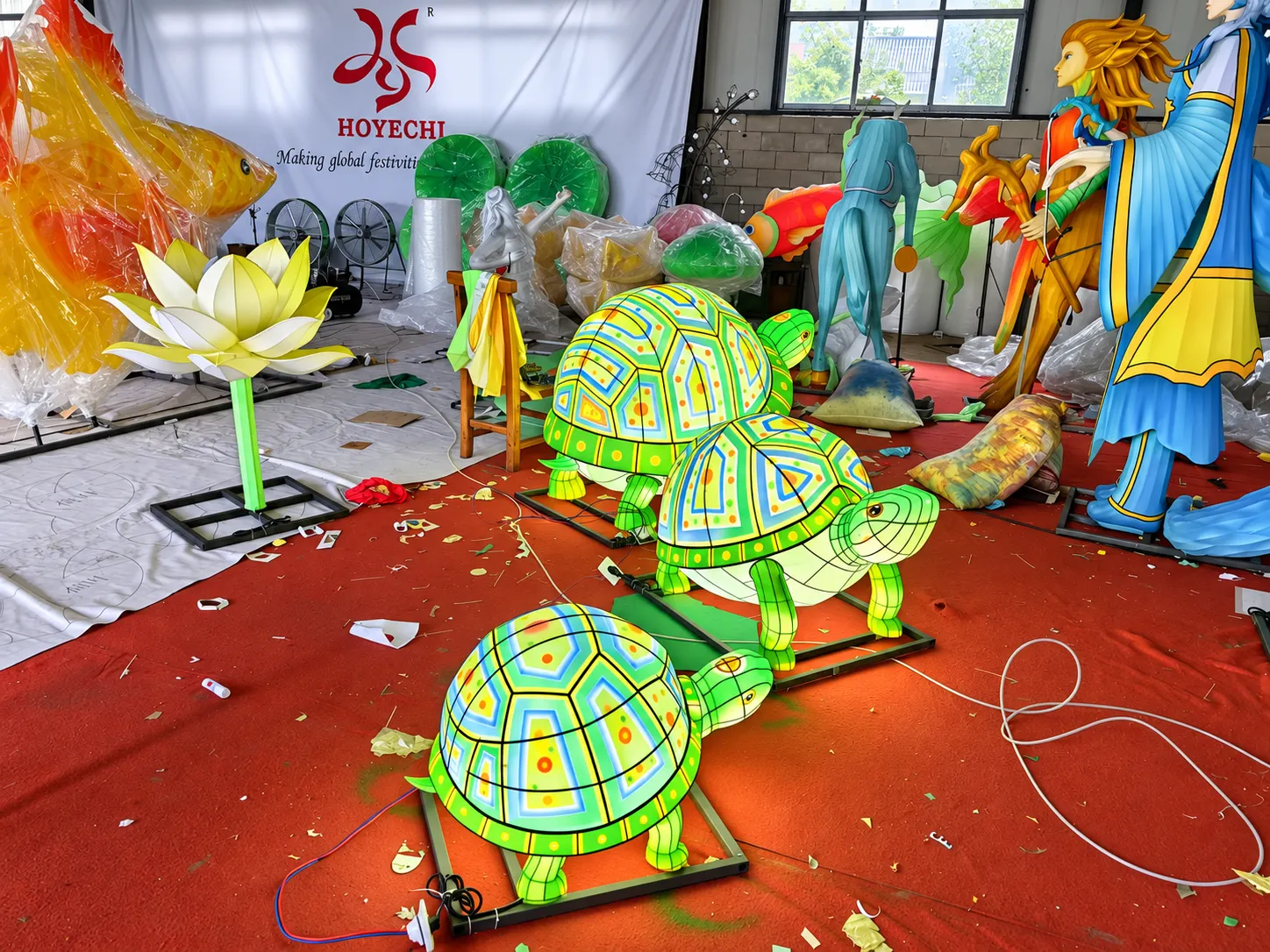 Illuminated turtle lantern sculptures in a custom lantern factory