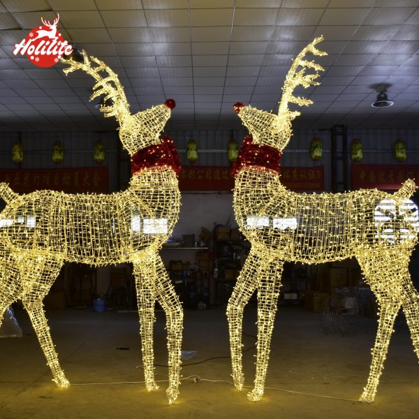 Golden upright reindeer light sculpture with red bow for outdoor Christmas display