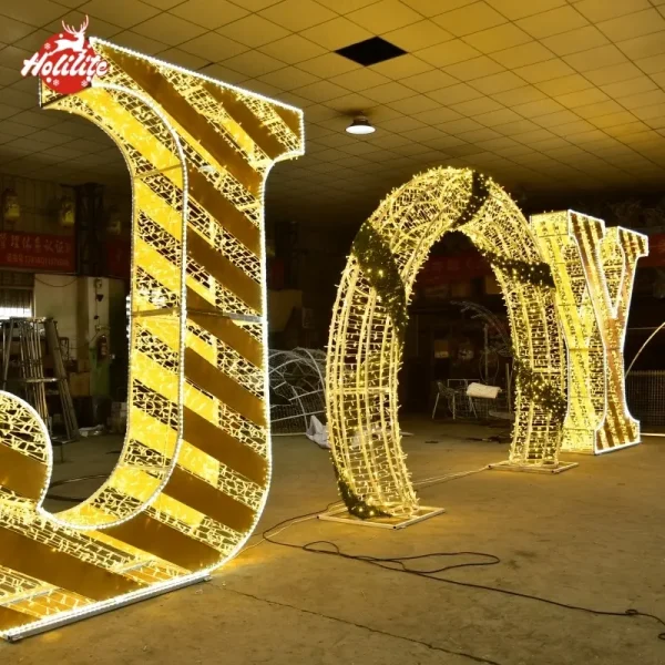 Large JOY light letters with gold metal panels and LED lighting